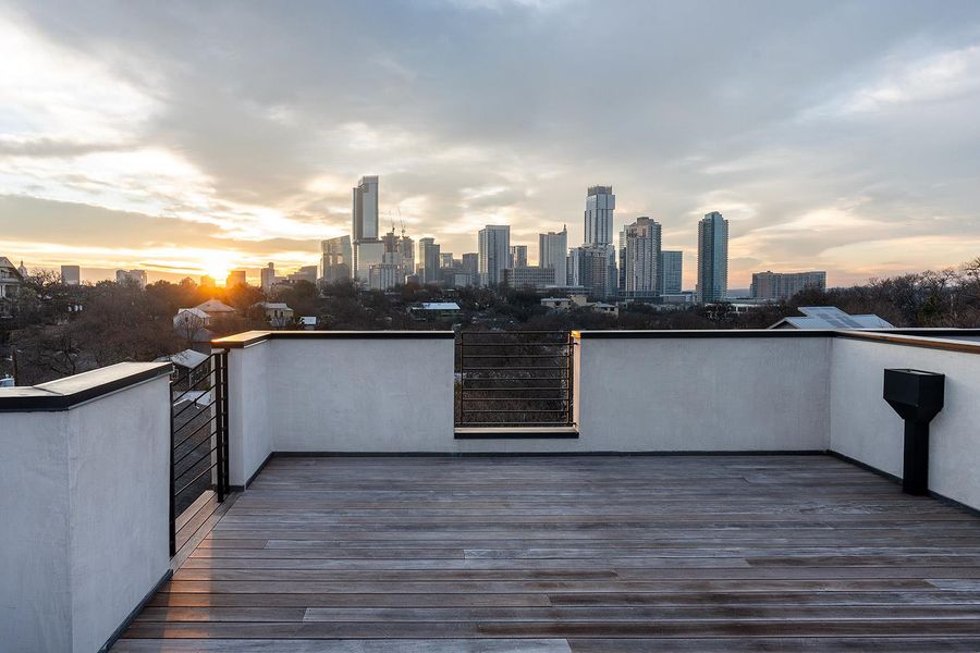 City skyline views unfold from this expansive rooftop deck, offering an ideal space for outdoor entertaining. City skyline views unfold from this expansive rooftop deck, offering an ideal space for outdoor entertaining.