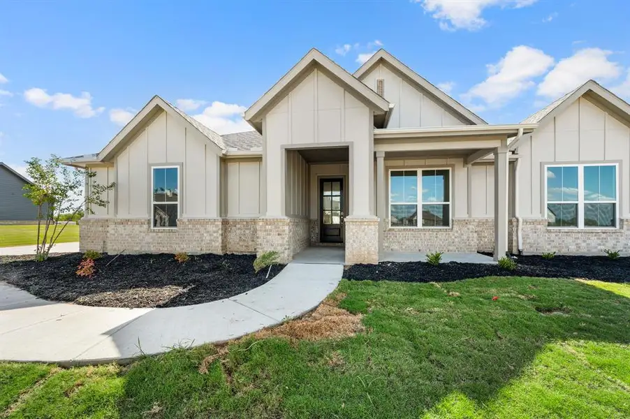 Front exterior of a new home in Saddleback Estates, Boyd, TX, highlighting curb appeal (Image 23). Front exterior of a new home in Saddleback Estates, Boyd, TX, highlighting curb appeal (Image 23).