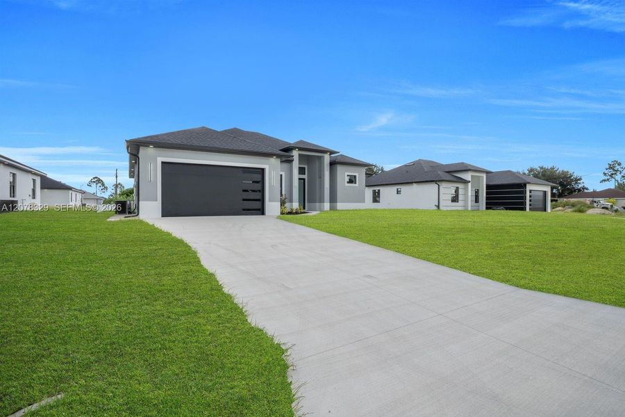Front exterior of a new home in , Lehigh Acres, FL, highlighting curb appeal (Image 2). Front exterior of a new home in , Lehigh Acres, FL, highlighting curb appeal (Image 2).