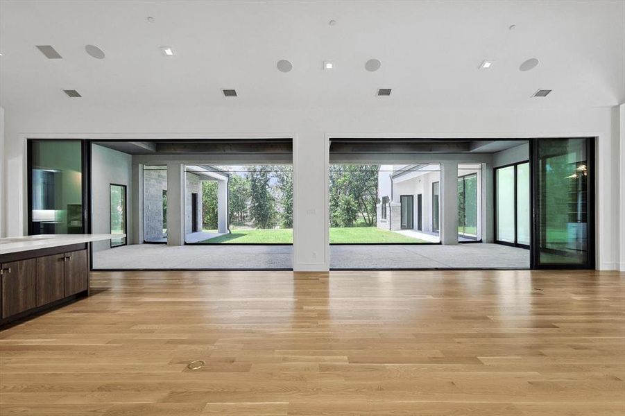 The great room at 1036 Hat Creek Road opens to an outdoor living area overlooking the acreage beyond.