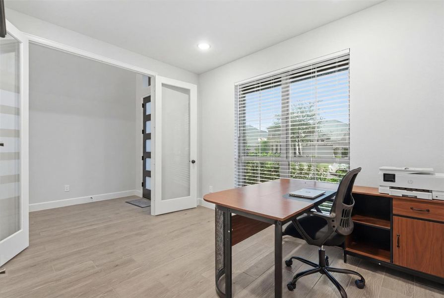 This bright, modern home office features large windows with ample natural light, stylish wood flooring, and sleek glass doors. It includes a spacious desk and storage, making it ideal for productivity. This bright, modern home office features large windows with ample natural light, stylish wood flooring, and sleek glass doors. It includes a spacious desk and storage, making it ideal for productivity.