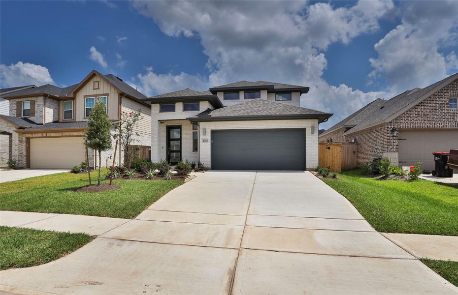 Front exterior of a new home in The Grand Prairie 40', Hockley, TX, highlighting curb appeal (Image 2).