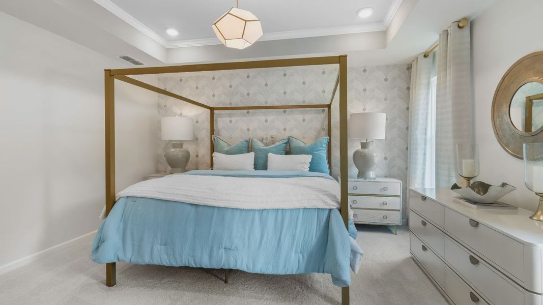 Stylish primary suite in new contruction townhome featuring soft textiles and calming neutral palette.