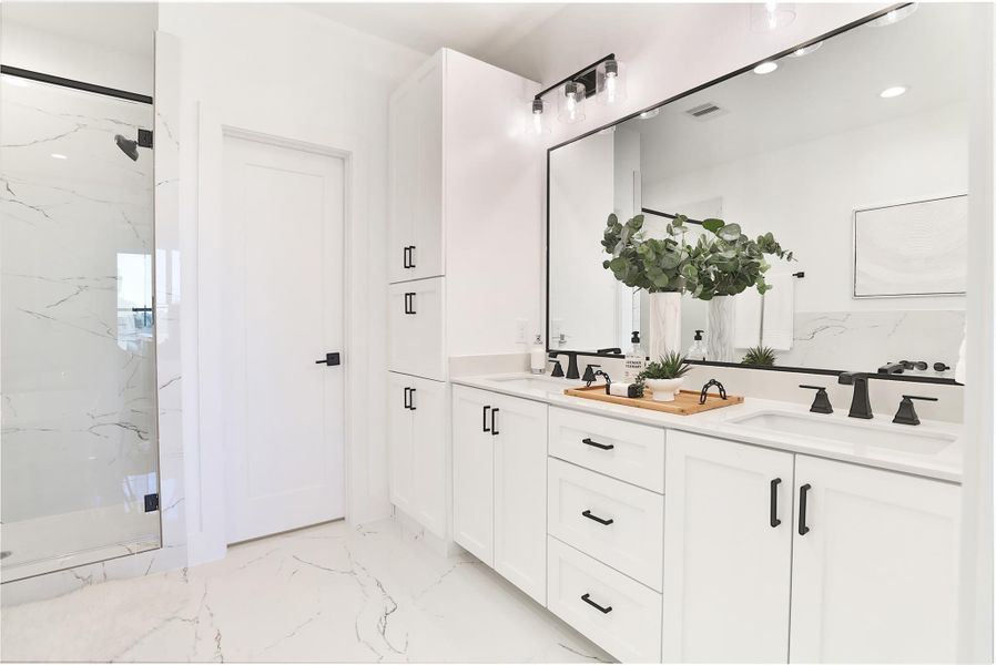 A luxurious primary bath suite featuring a spacious walk-in shower with matte gray hexagon mosaic floor tiles.