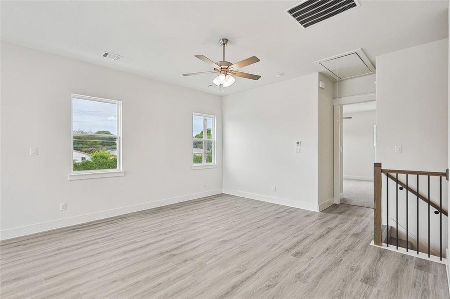 Spare room featuring light hardwood / wood-style flooring and ceiling fan