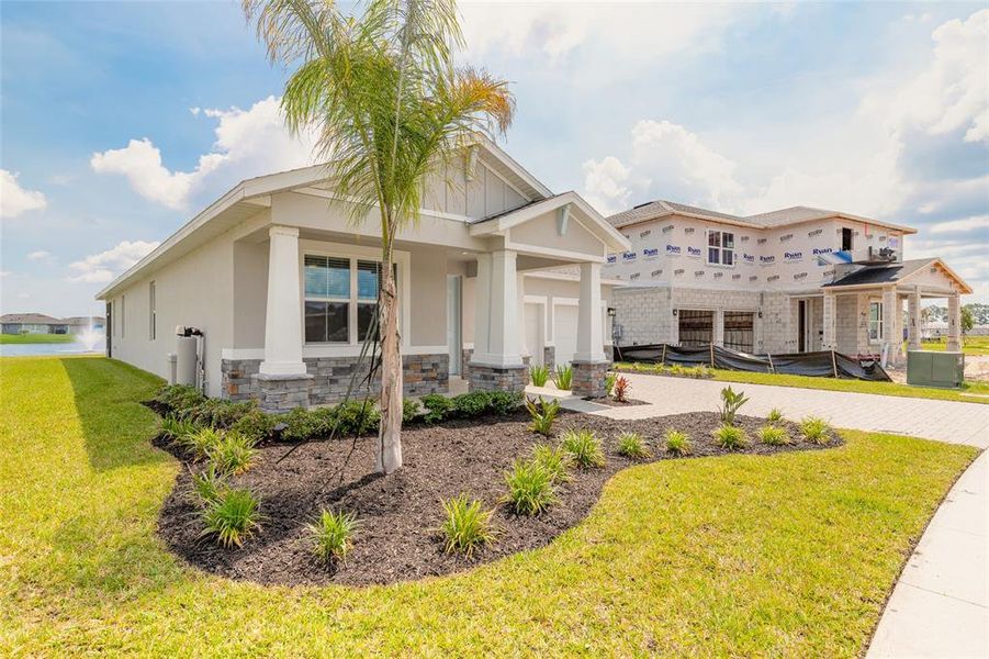Front exterior of a new home in The Palms at Venetian Bay, New Smyrna Beach, FL, highlighting curb appeal (Image 21). Front exterior of a new home in The Palms at Venetian Bay, New Smyrna Beach, FL, highlighting curb appeal (Image 21).