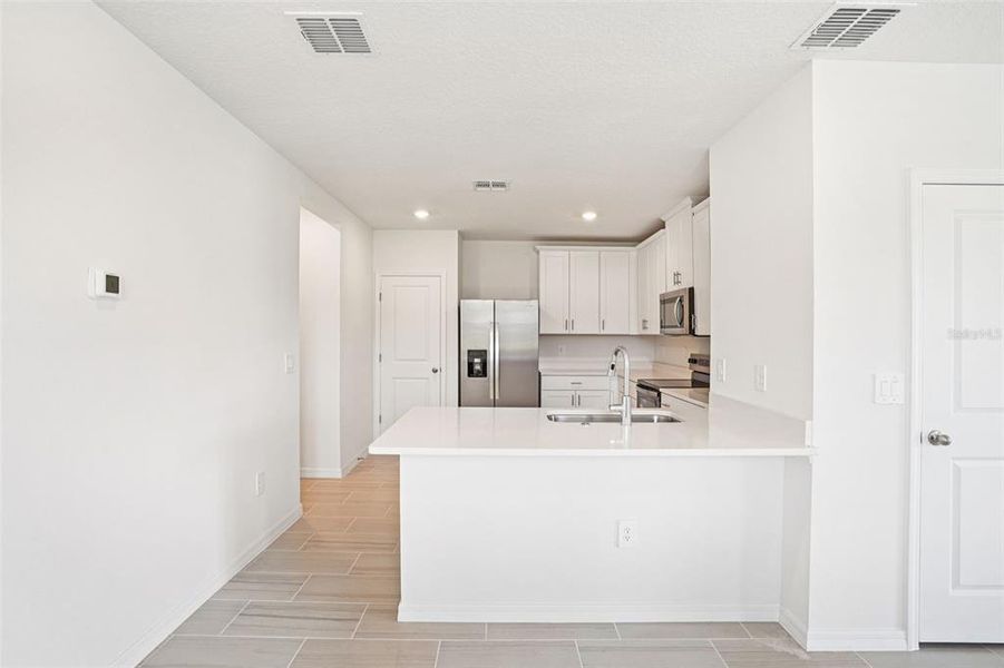 Furnished interior view inside a new home in Ridgehaven - Villas, Ormond Beach (Image 4).