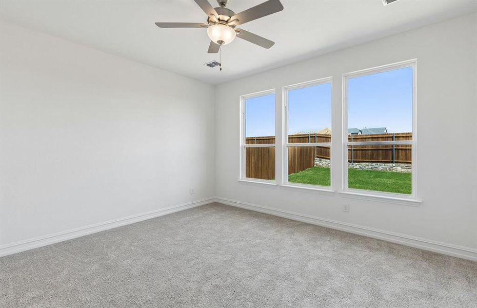 Primary bedroom with large windows