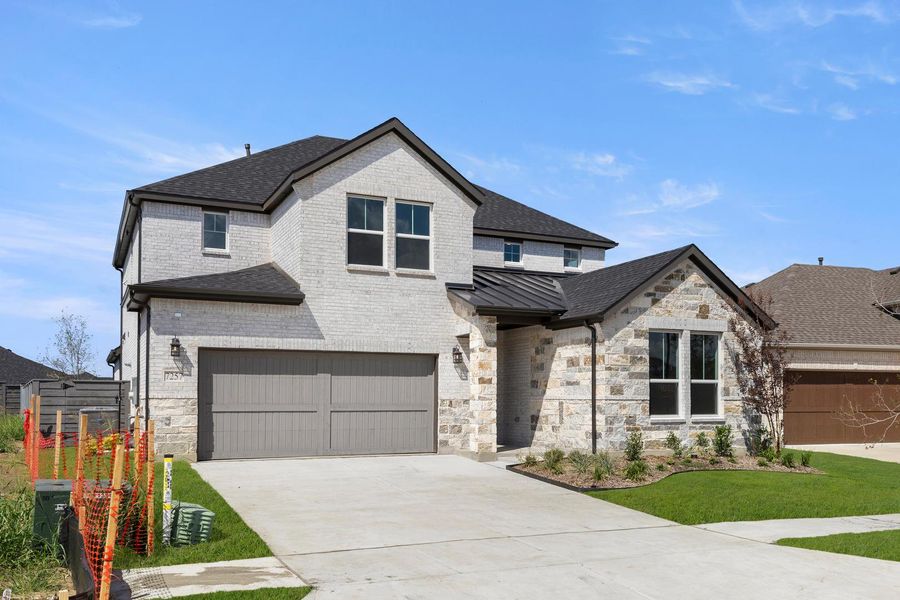 Front exterior of a new home in Discovery Collection at Union Park, Little Elm, TX, highlighting curb appeal (Image 2). Front exterior of a new home in Discovery Collection at Union Park, Little Elm, TX, highlighting curb appeal (Image 2).