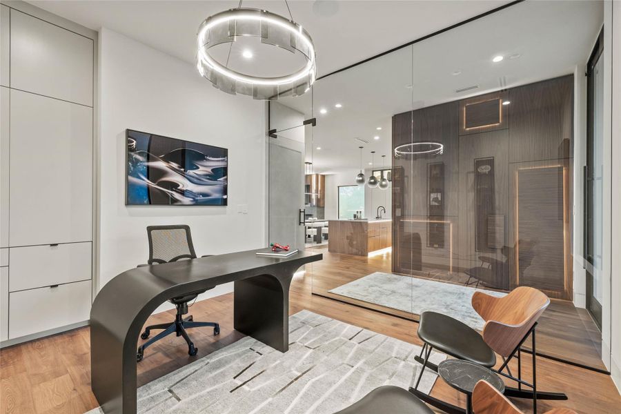 Dedicated workspace featuring a curved desk and integrated storage cabinetry