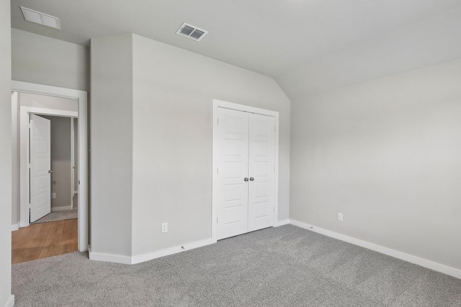 Bedroom in the Oscar home plan by Trophy Signature Homes