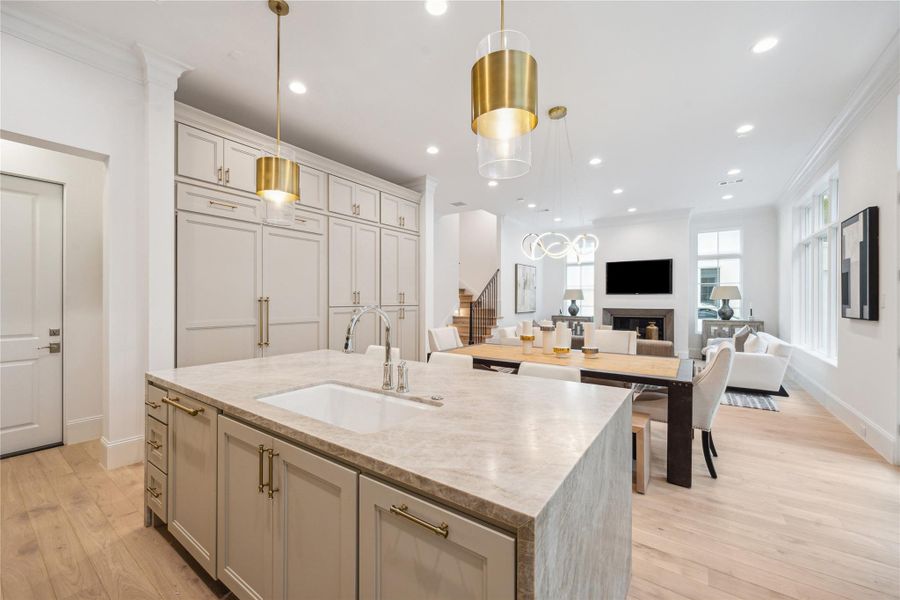 Leathered Taj Mahal Quartzite waterfall island and undermount Porcelain sink with Kallista faucet complete this luxury kitchen. Ample prep space, storage space, and island seating make this space functional and stunning. Leathered Taj Mahal Quartzite waterfall island and undermount Porcelain sink with Kallista faucet complete this luxury kitchen. Ample prep space, storage space, and island seating make this space functional and stunning.