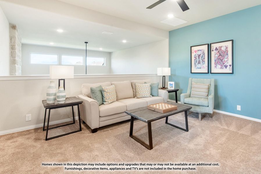 Basement living room with beige sofa, teal accent wall, carpet, and ceiling fan Basement living room with beige sofa, teal accent wall, carpet, and ceiling fan