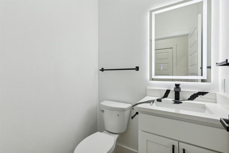 Bathroom featuring vanity and toilet