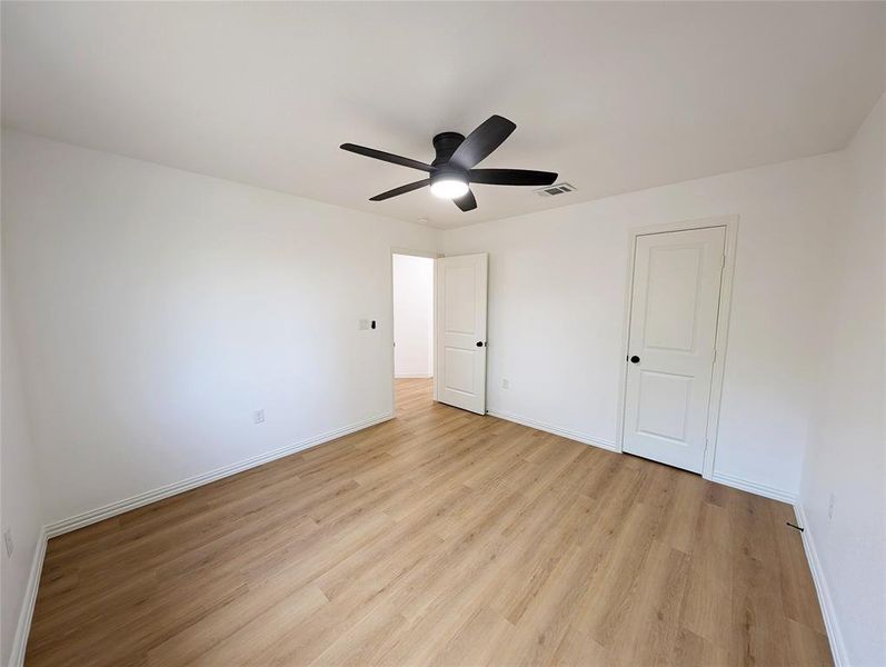 Unfurnished bedroom with ceiling fan and light hardwood / wood-style flooring