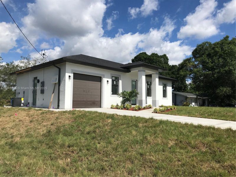 Front exterior of a new home in , Lehigh Acres, FL, highlighting curb appeal (Image 19). Front exterior of a new home in , Lehigh Acres, FL, highlighting curb appeal (Image 19).