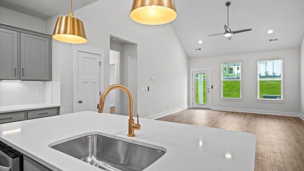 Highly skilled design choices create a clean, open kitchen with a central island at Silo Ridge by DRB Homes in Anderson, SC