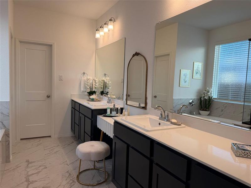 En-Suite Primary Bath with Separate Vanities and a Charming Sit-Down Makeup Table