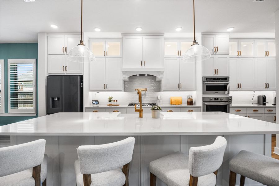 Beautifully appointed kitchen with ceiling-height cabinetry, refined gold hardware, and a timeless, elevated design