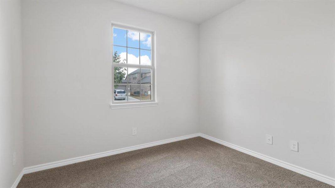 Carpeted empty room featuring baseboards