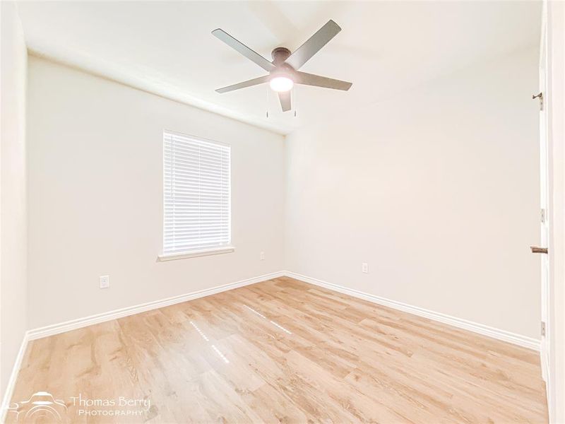 Spare room featuring light wood finished floors and ceiling fan Spare room featuring light wood finished floors and ceiling fan
