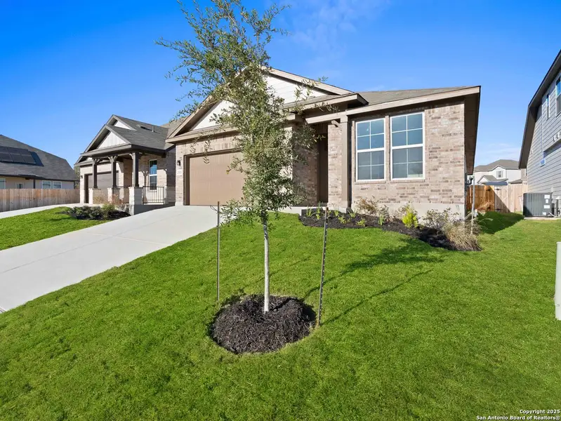 Front exterior of a new home in Hunter's Ranch, San Antonio, TX, highlighting curb appeal (Image 1). Front exterior of a new home in Hunter's Ranch, San Antonio, TX, highlighting curb appeal (Image 1).