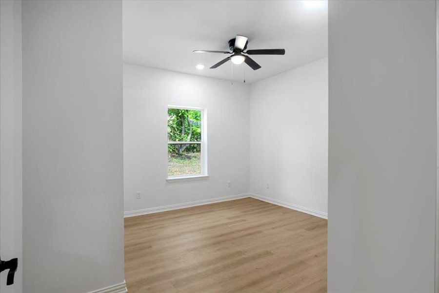 Unfurnished room with light wood-style flooring, ceiling fan, and recessed lighting