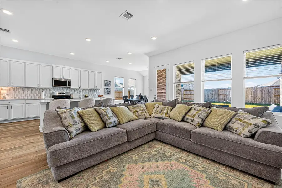 Bright, open-concept living room filled with natural light. Bright, open-concept living room filled with natural light.