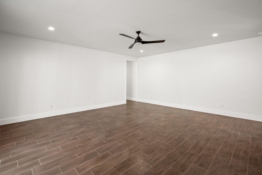 Spare room with recessed lighting, a ceiling fan, and dark wood finished floors