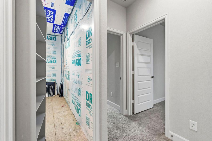 A hidden storage room measuring approximately 13' x 5' provides valuable extra space for seasonal décor, luggage, or additional household storage.