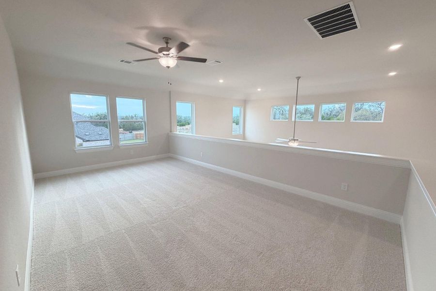 Spare room with light carpet, ceiling fan, and recessed lighting