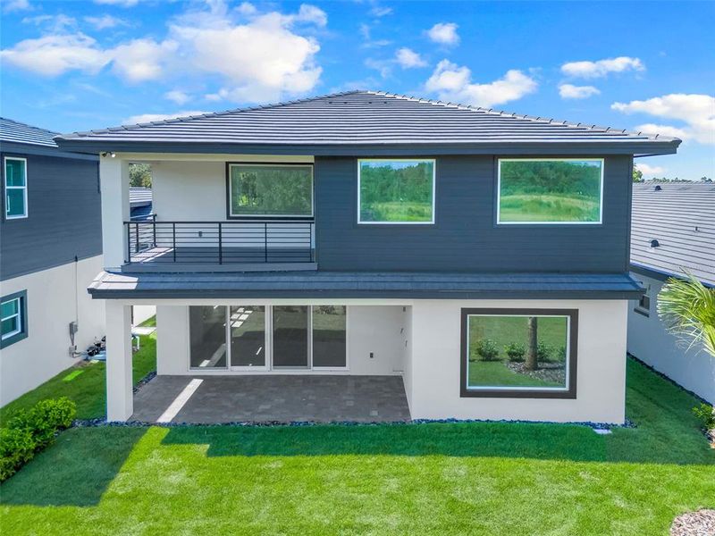 Exterior details and patio area of a home in Hampton Green at Providence, Davenport (Image 34).