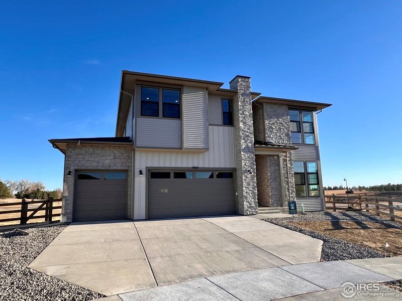 Front exterior of a new home in Kitchel Lake at Serratoga Falls, Timnath, CO, highlighting curb appeal (Image 1). Front exterior of a new home in Kitchel Lake at Serratoga Falls, Timnath, CO, highlighting curb appeal (Image 1).