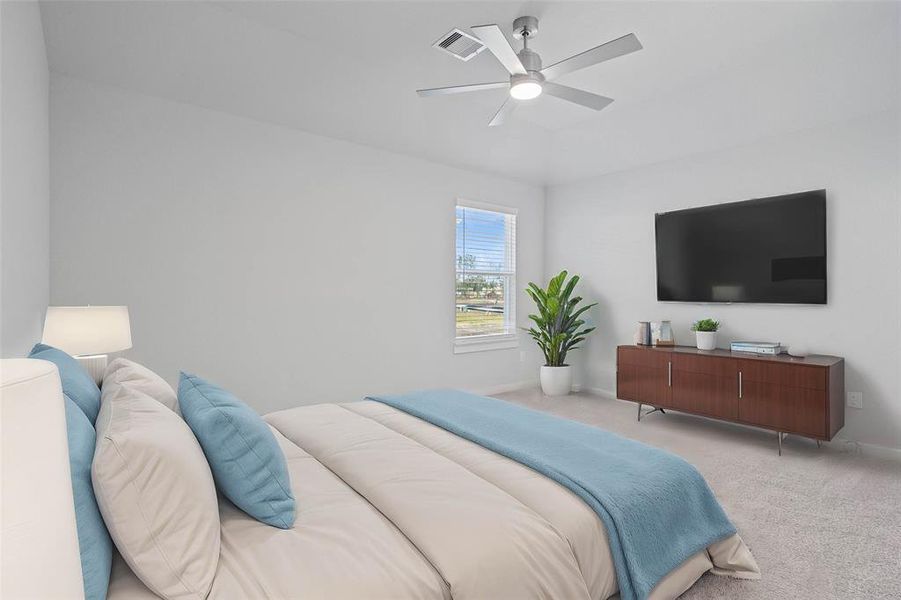 Secondary bedroom features plush carpet, custom paint, ceiling fan with lighting and a large window with privacy blinds.