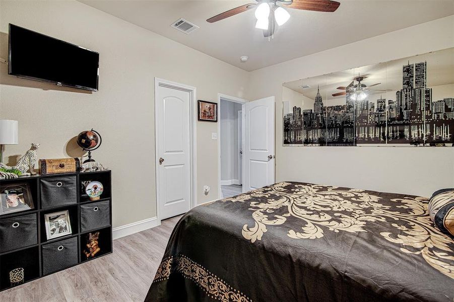 Bedroom with ceiling fan and light wood-type flooring