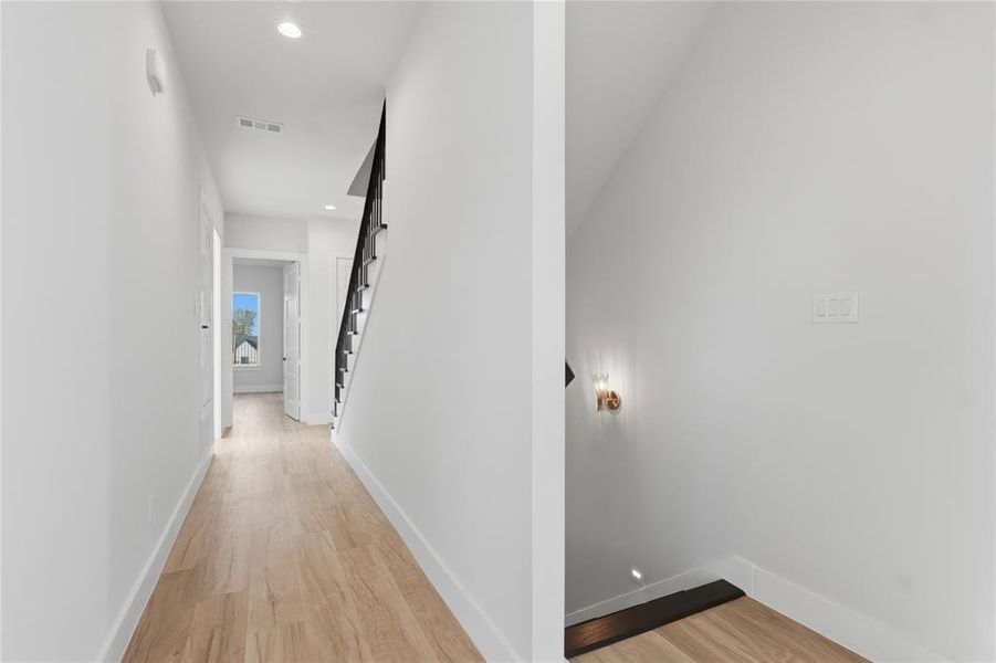 Hall featuring recessed lighting and light wood-style flooring Hall featuring recessed lighting and light wood-style flooring