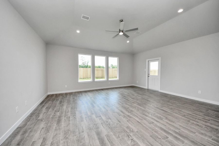 Take another glimpse into the heart of the home with this additional view of the family room—a sprawling space ready to accommodate all your gatherings. Sample photo of completed home with similar floor plan. Actual colors and selections may vary.