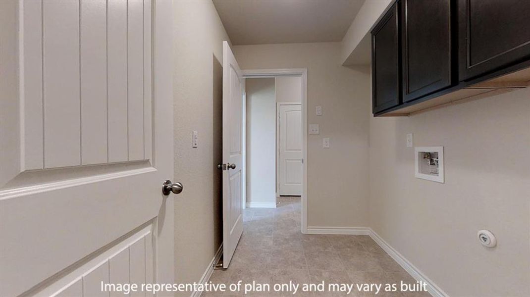 Laundry room featuring washer hookup and cabinet space Laundry room featuring washer hookup and cabinet space