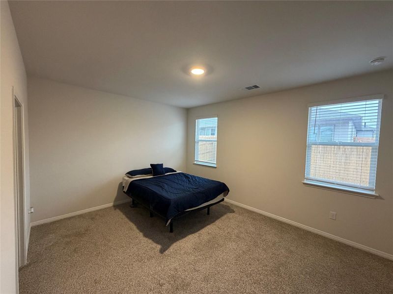 Bedroom featuring baseboards and carpet