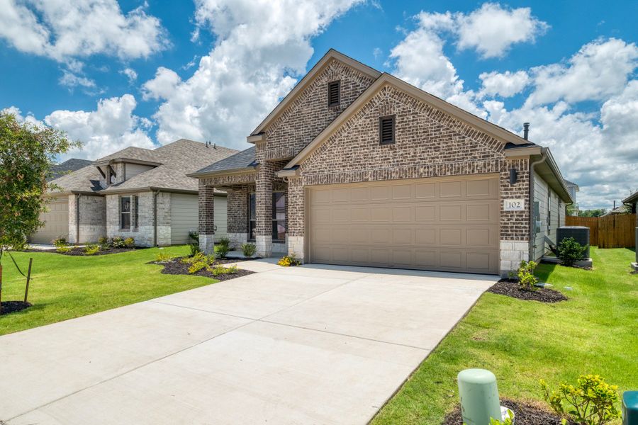 Front exterior of a new home in Prairie Winds, Hutto, TX, highlighting curb appeal (Image 19).