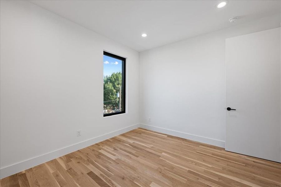 2nd bedroom featuring light wood-style flooring and recessed lighting 2nd bedroom featuring light wood-style flooring and recessed lighting