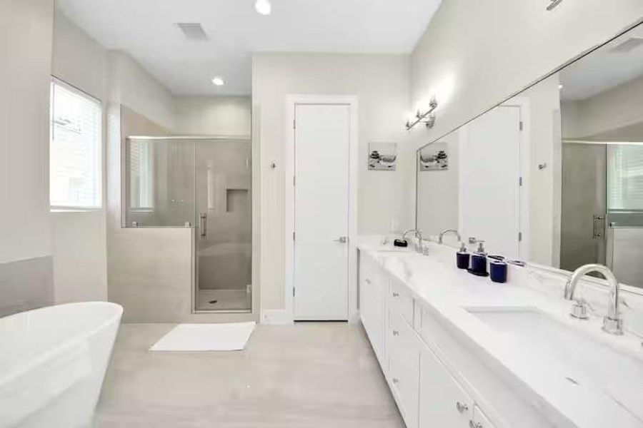 The primary bath gives you both options: a freestanding soaking tub when you want to unwind and a separate walk-in shower for the everyday routine.