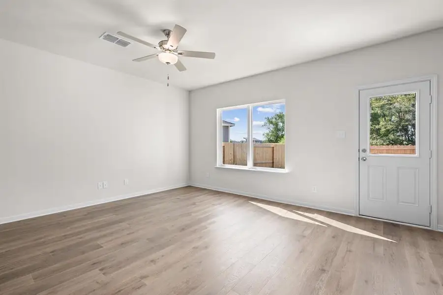 Spare room featuring light wood-style flooring and a ceiling fan Spare room featuring light wood-style flooring and a ceiling fan