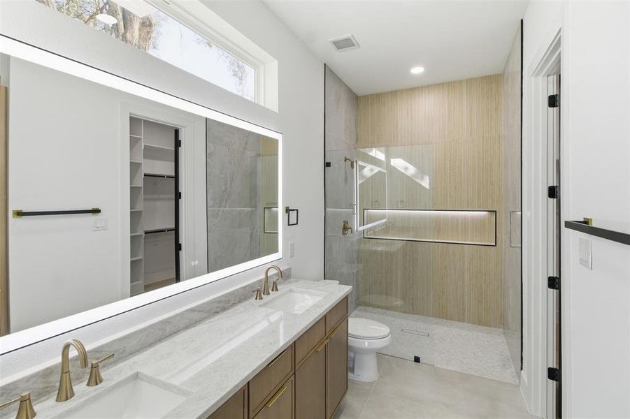 Full bathroom featuring walk in shower, double vanity, a spacious closet, recessed lighting, and light tile patterned flooring