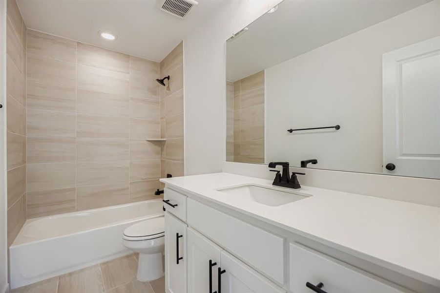 Full bathroom featuring vanity, tub / shower combination, and recessed lighting Full bathroom featuring vanity, tub / shower combination, and recessed lighting