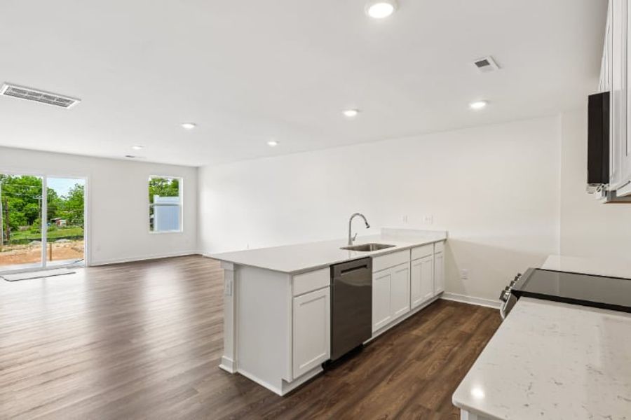 A kitchen with white cabinets.
