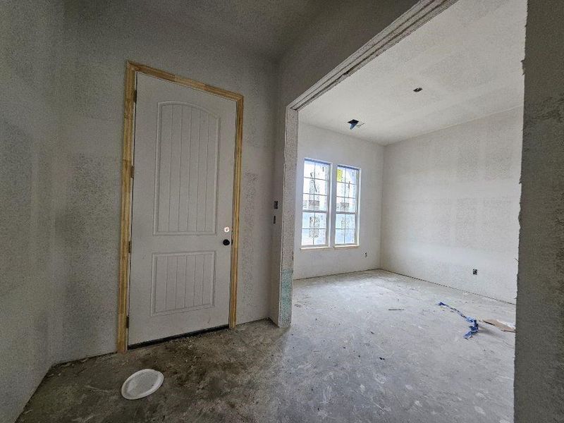 Newly constructed home featuring a brick and stone exterior, an arched entryway, an attached garage, and decorative gable brackets Newly constructed home featuring a brick and stone exterior, an arched entryway, an attached garage, and decorative gable brackets
