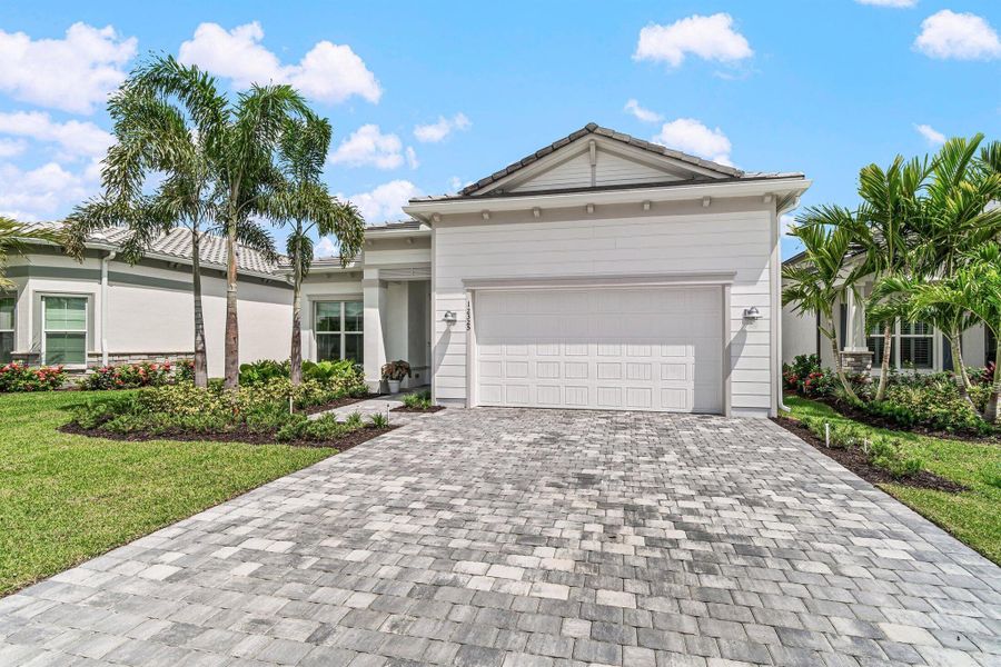 Front exterior of a new home in Avondale at Avenir, Palm Beach Gardens, FL, highlighting curb appeal (Image 24).