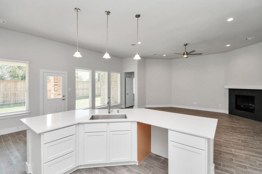 All of this overlooks your expansive family room, creating a perfect space for culinary delights and family gatherings. Sample photo of completed home with similar floor plan. Actual colors and selections may vary. All of this overlooks your expansive family room, creating a perfect space for culinary delights and family gatherings. Sample photo of completed home with similar floor plan. Actual colors and selections may vary.