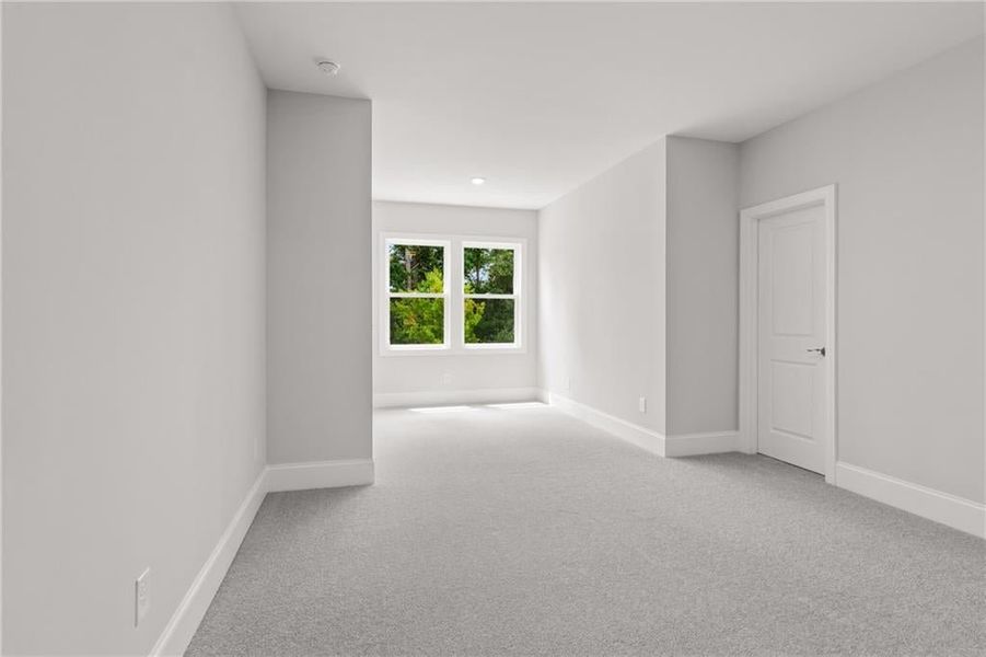 A BEAUTIFUL SECONDARY BEDROOM WITH ITS OWN SITTING AREA, FANTASTIC WALK IN CLOSET AND FULL BATH